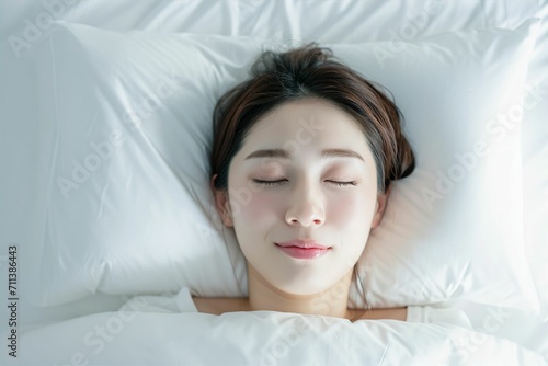 ベッドで寝ている日本人女性のポートレート（睡眠・うたたね・寝る・快眠・休息） photo