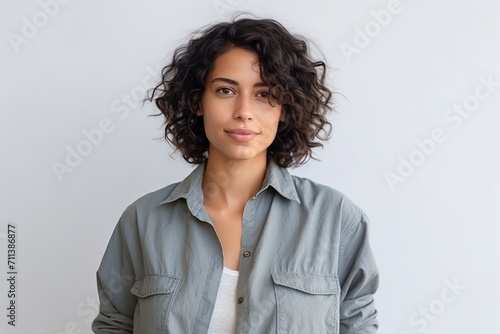 Portrait of a beautiful young woman with curly hair looking at camera