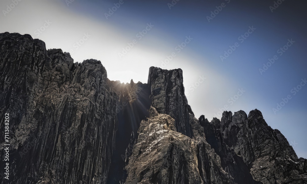Majestic Mountain Peaks with Sunrays in Clear Sky