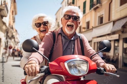 An elderly cheerful emotional couple in oscars rides a scooter along a city street