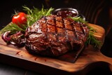 Baked juicy meat on the barbecue lies on a board on a black background. Grilled meat