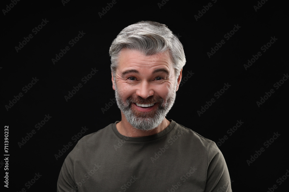 Personality concept. Portrait of happy man on black background