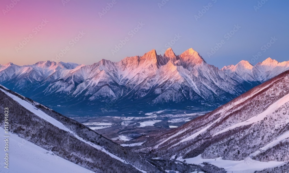 Snow-Capped Mountain Peaks at Sunset with Vivid Sky
