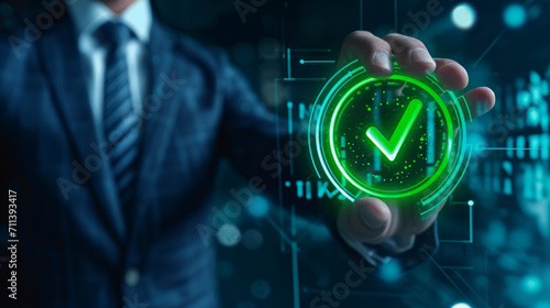 Green check mark for compliance, certification or audit concept with a business man holding a digital hologram of green compliance tick symbol photo