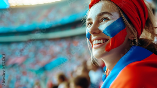 Happy Russian woman supporter with face painted in Russia flag colors, white blue and red, Russian fan at a sports event such as football or rugby match, blurry stadium background, copy space photo