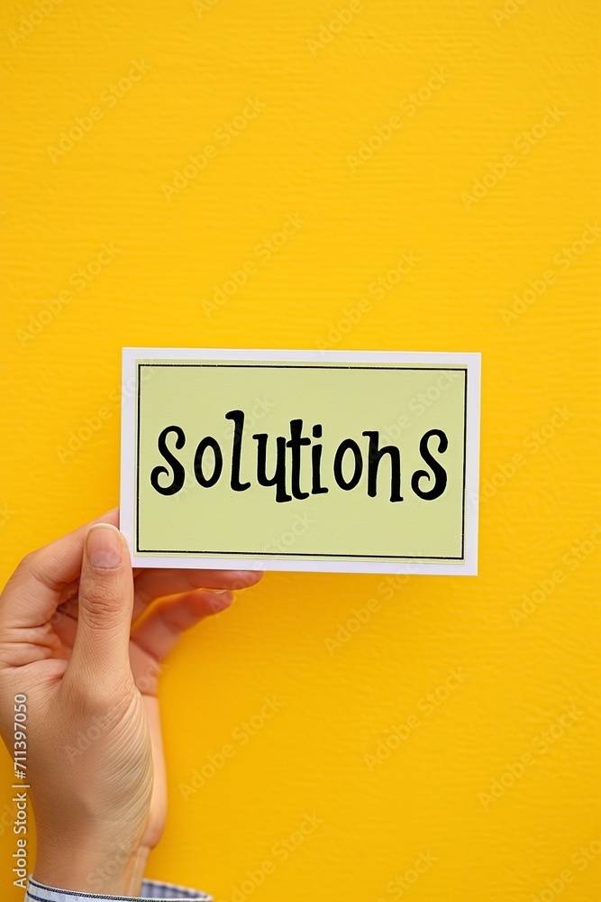 hands holding a sign that says Solution on yellow background hands holding a sign that says Solution on yellow background