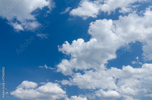 Fluffy white cumulus clouds in a blue sky on a beautiful day  natural soft background with copy space for text
