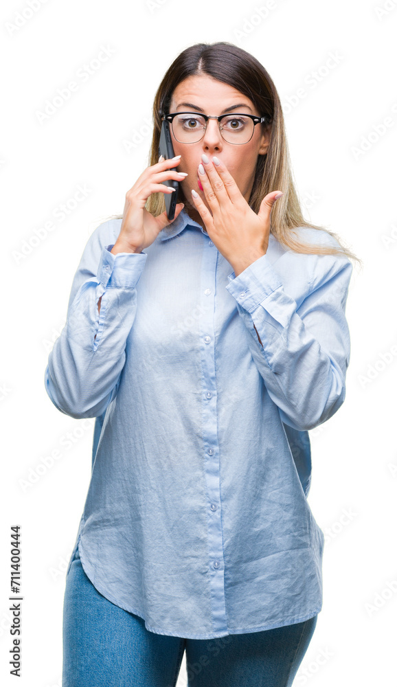 Young beautiful business woman speaking calling using smartphone over isolated background cover mouth with hand shocked with shame for mistake, expression of fear, scared in silence, secret concept Young beautiful business woman speaking calling using smartphone over isolated background cover mouth with hand shocked with shame for mistake, expression of fear, scared in silence, secret concept