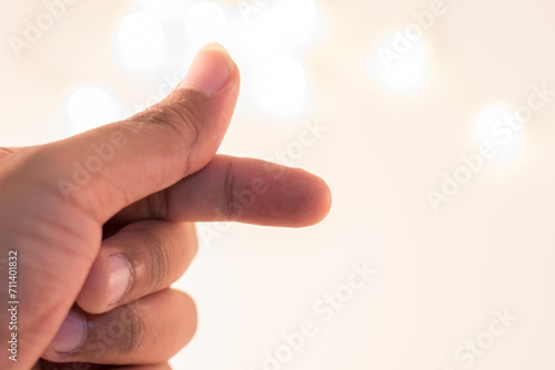 Finger heart, Close up of man hand pointing with finger on white bokeh background