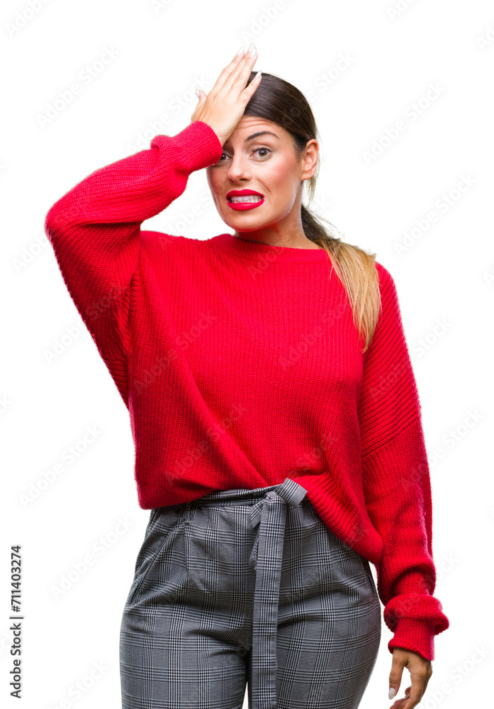 Young beautiful business woman wearing winter sweater over isolated background surprised with hand on head for mistake, remember error. Forgot, bad memory concept. Young beautiful business woman wearing winter sweater over isolated background surprised with hand on head for mistake, remember error. Forgot, bad memory concept.