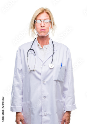 Middle age blonde doctor woman over isolated background puffing cheeks with funny face. Mouth inflated with air, crazy expression.