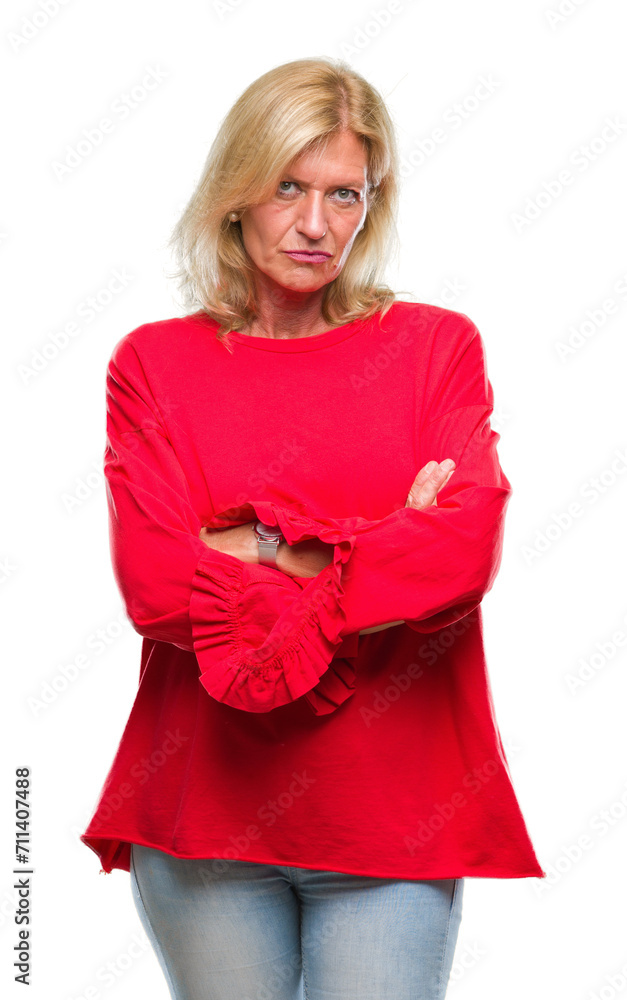 Middle age blonde woman over isolated background skeptic and nervous, disapproving expression on face with crossed arms. Negative person. Middle age blonde woman over isolated background skeptic and nervous, disapproving expression on face with crossed arms. Negative person.
