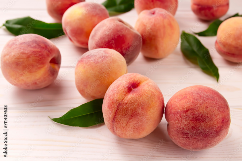Fresh peaches on a wooden table. Summer peach fruit background. Fresh peaches on a wooden table. Summer peach fruit background.