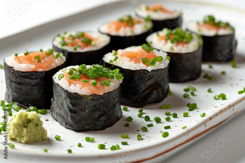 Sushi rolls on white plate on white background