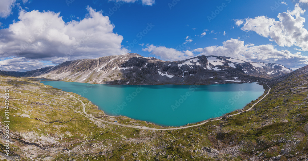 Aerial view over mountain landscape with lake and unpaved road, Strynfjellet, Norway