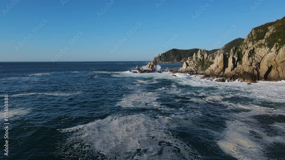 Raging sea in the morning at dawn Waves roll on the rocky shore Spray soars into the sky Raging sea in the morning at dawn Waves roll on the rocky shore Spray soars into the sky
