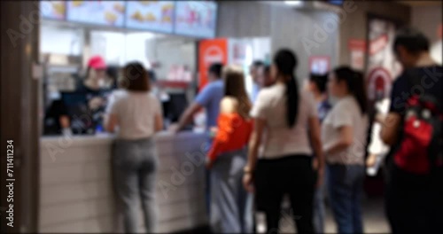 A Group of People Waiting in Line at a Fast Food Restaurant. Blurred background 4K video photo