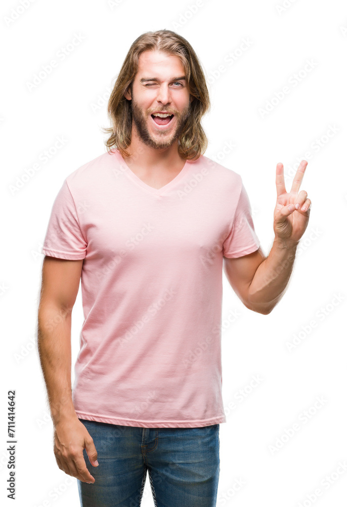 Young handsome man with long hair over isolated background smiling with happy face winking at the camera doing victory sign. Number two. Young handsome man with long hair over isolated background smiling with happy face winking at the camera doing victory sign. Number two.