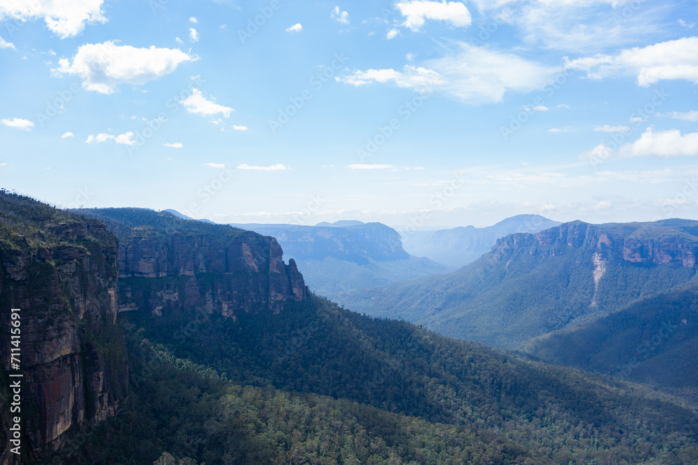 Rugged mountain ranges dip into tree filled valley seen from Govetts Leap Rugged mountain ranges dip into tree filled valley seen from Govetts Leap