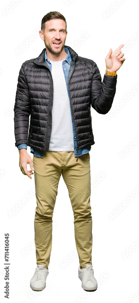 Handsome man wearing winter coat with a big smile on face, pointing with hand and finger to the side looking at the camera. Handsome man wearing winter coat with a big smile on face, pointing with hand and finger to the side looking at the camera.