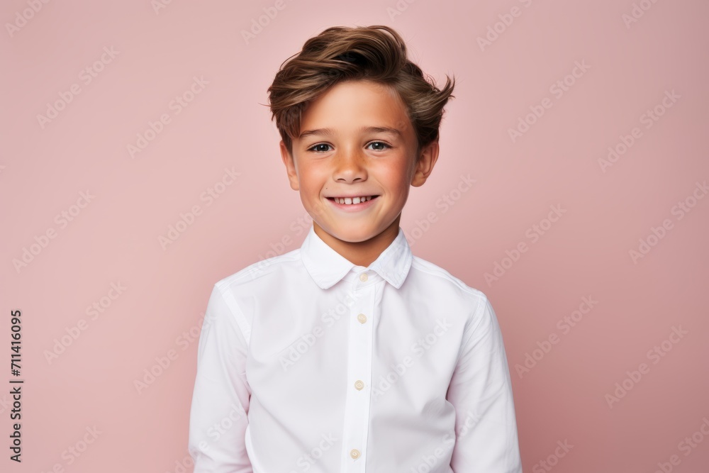 Portrait of a cute little boy in a white shirt on a pink background. Portrait of a cute little boy in a white shirt on a pink background.