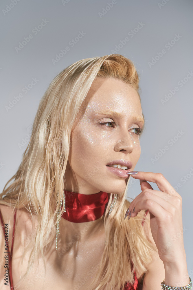 good looking young female model with highlighter on face and green eyes posing and looking away good looking young female model with highlighter on face and green eyes posing and looking away