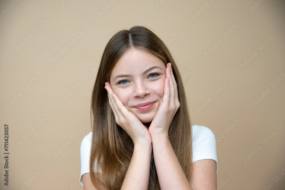 beautiful, cool, cute tween, teenager girl with long hair is posing in front of brown background beautiful, cool, cute tween, teenager girl with long hair is posing in front of brown background