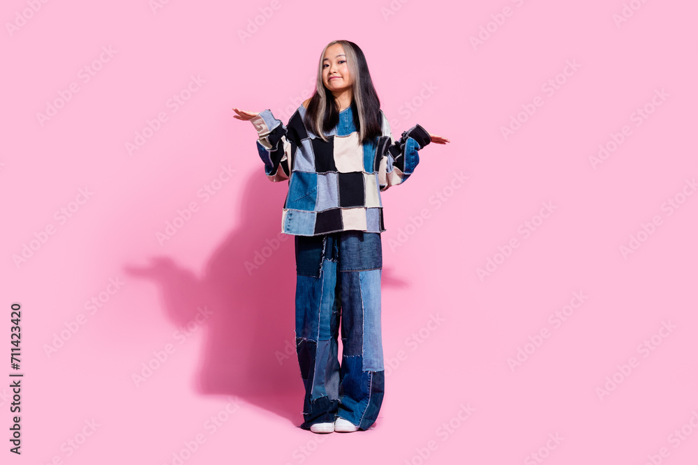 Full length photo of clueless questioned person raise hands shrug shoulders empty space isolated on pink color background Full length photo of clueless questioned person raise hands shrug shoulders empty space isolated on pink color background