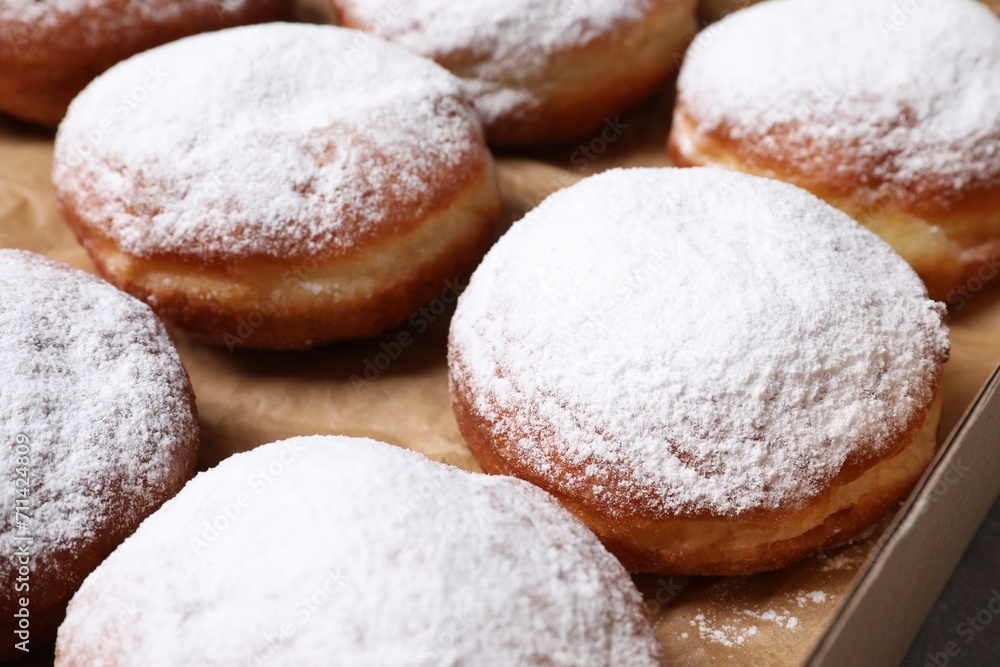 Delicious buns with powdered sugar in box, closeup Delicious buns with powdered sugar in box, closeup