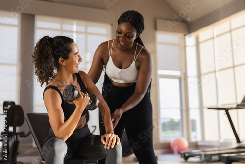 women African American plus-size coach training latina female dumbbell lifts weights exercise in gym. sport training weights fitness, Exercise to lose weight, take care of health.