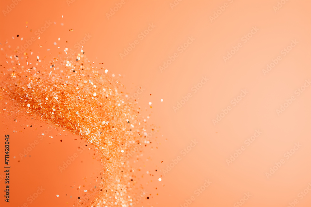Orange abstract background with sparkling golden confetti explosion. Festive backdrop with space for text, holiday concept.