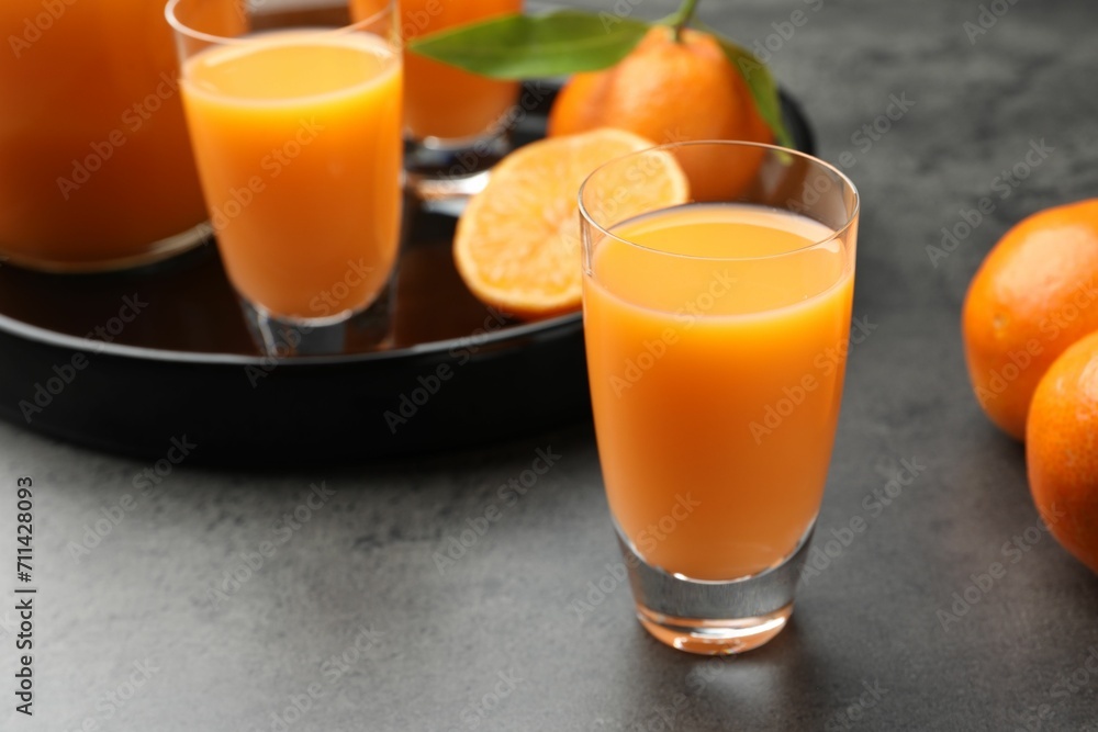 Delicious tangerine liqueur and fresh fruits on grey table, closeup Delicious tangerine liqueur and fresh fruits on grey table, closeup
