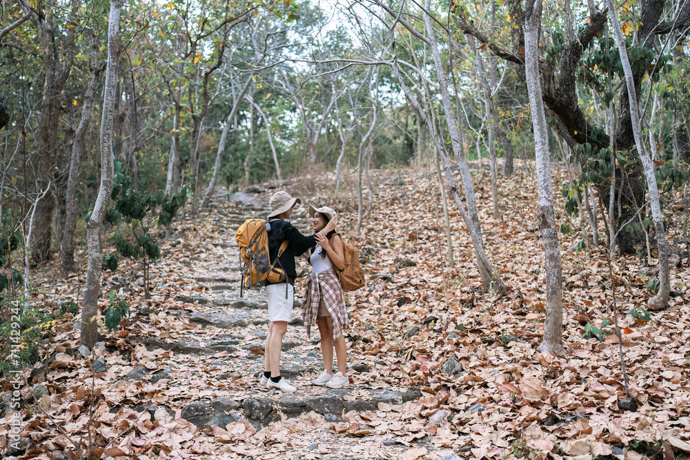 Happy LGBT Lesbian couple Travelers Hiking with Backpacks in forest Trail. LGBT Lesbian Couple Hikers with backpacks walks in mountains in vacation