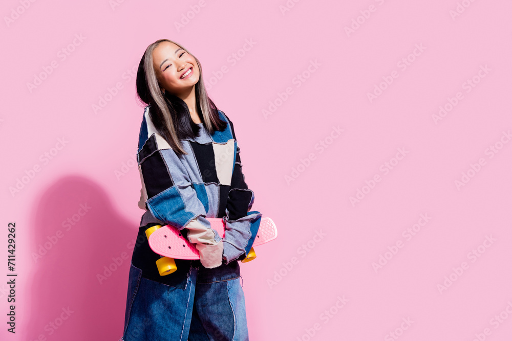 Photo of satisfied girl with dyed hairstyle dressed jeans pullover hold skateboard near sale empty space isolated on pink color background Photo of satisfied girl with dyed hairstyle dressed jeans pullover hold skateboard near sale empty space isolated on pink color background