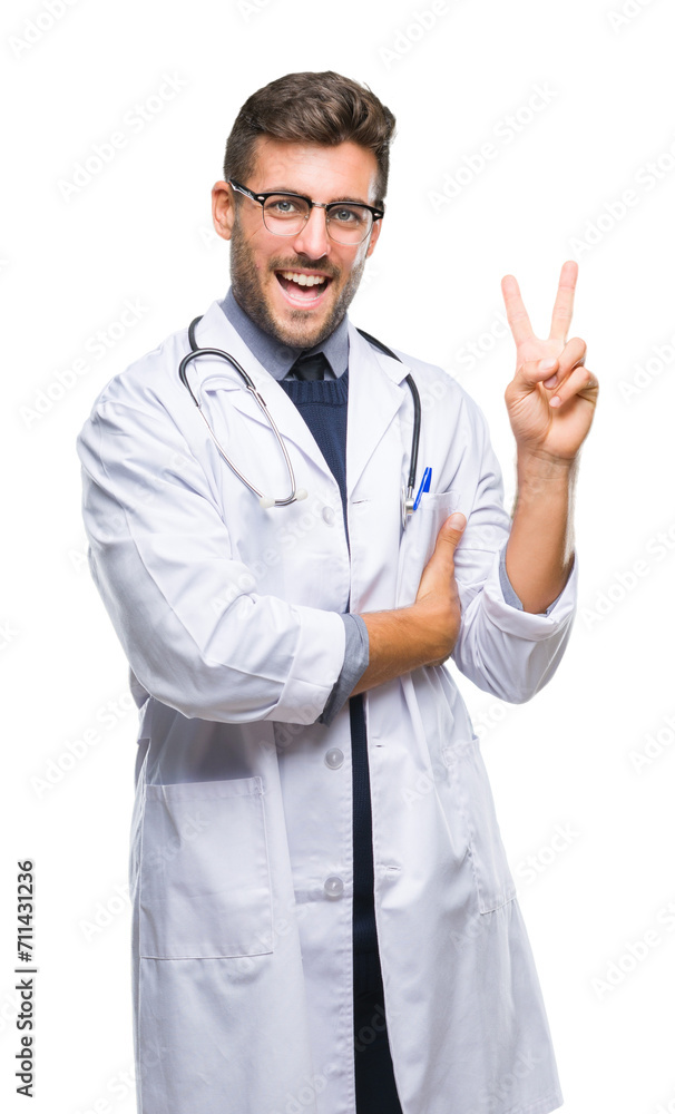 Young handsome doctor man over isolated background smiling with happy face winking at the camera doing victory sign. Number two. Young handsome doctor man over isolated background smiling with happy face winking at the camera doing victory sign. Number two.