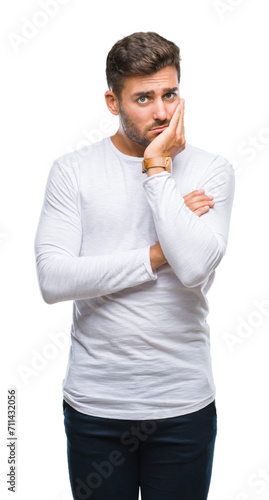 Young handsome man over isolated background thinking looking tired and bored with depression problems with crossed arms.
