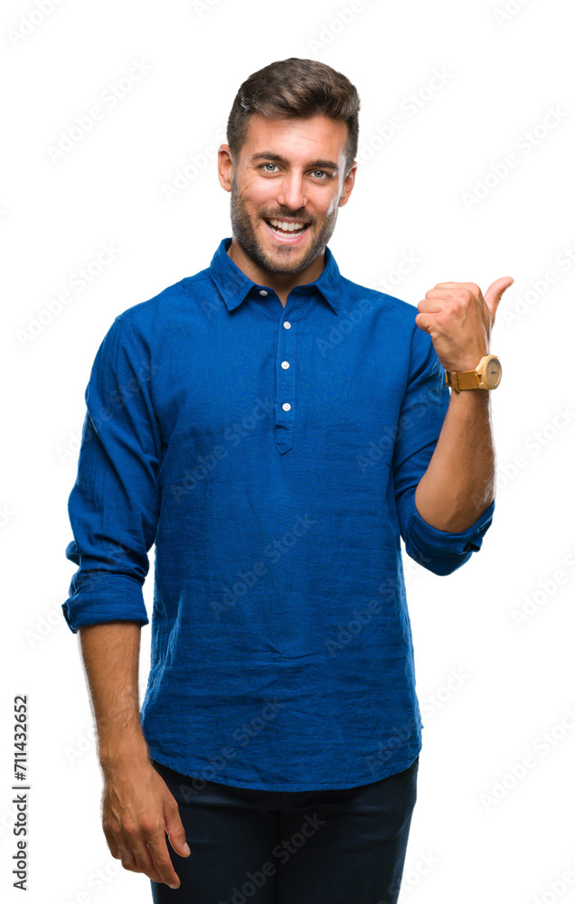 Young handsome man over isolated background smiling with happy face looking and pointing to the side with thumb up. Young handsome man over isolated background smiling with happy face looking and pointing to the side with thumb up.
