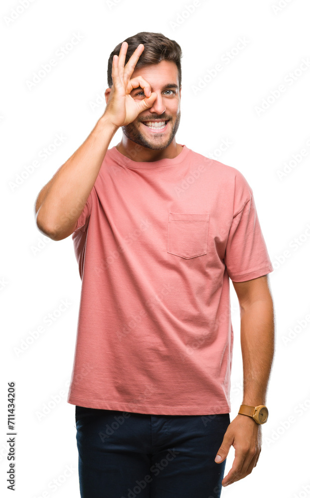 Young handsome man over isolated background doing ok gesture with hand smiling, eye looking through fingers with happy face. Young handsome man over isolated background doing ok gesture with hand smiling, eye looking through fingers with happy face.