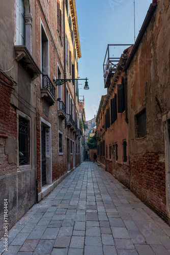 Lonely path way along the Venetian city with high facades and mystic shadows © Wolfgang Hauke