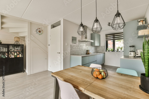 Modern kitchen interior with stylish dining area photo