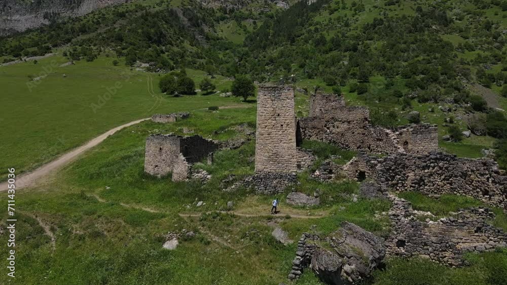 Medieval battle towers on the slope of the mountains in the village of Keni. Caucasus, Ossetia. The mountain is covered with forest Medieval battle towers on the slope of the mountains in the village of Keni. Caucasus, Ossetia. The mountain is covered with forest