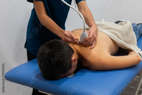 Physical therapy session with ultrasound treatment on back