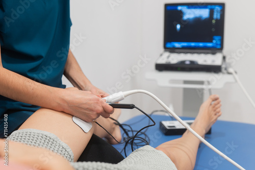 Patient undergoing a knee ultrasound examination photo