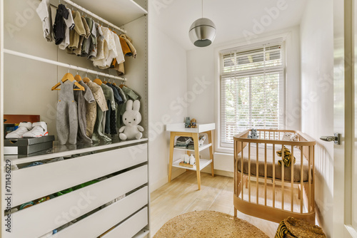 Modern baby room with organized wardrobe and crib photo