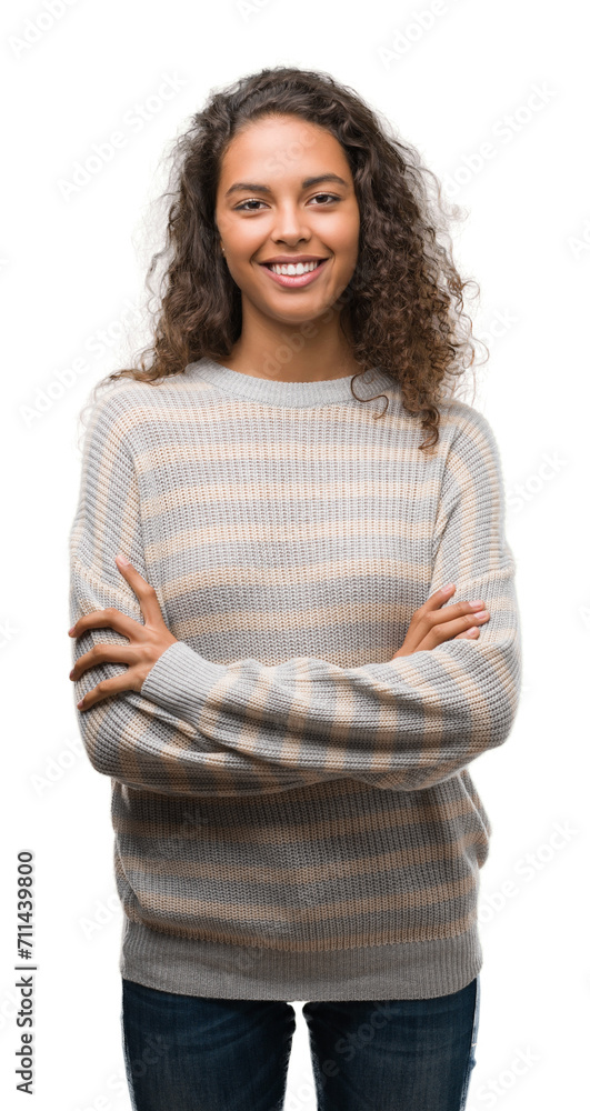 Beautiful young hispanic woman wearing stripes sweater happy face smiling with crossed arms looking at the camera. Positive person. Beautiful young hispanic woman wearing stripes sweater happy face smiling with crossed arms looking at the camera. Positive person.