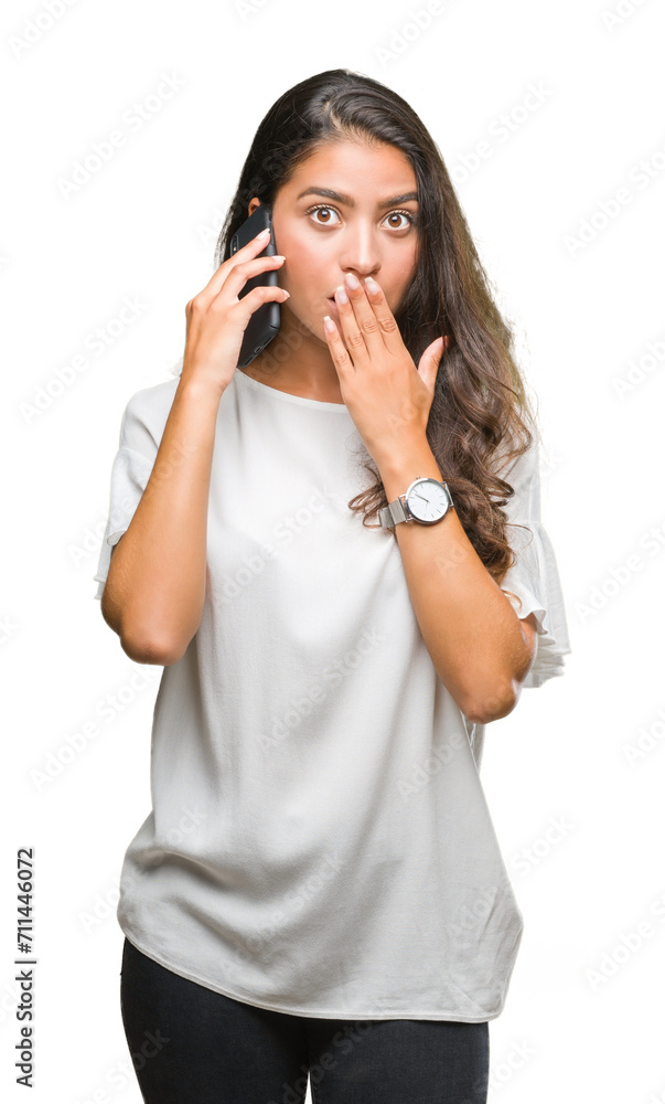 Young beautiful arab woman talking on the phone over isolated background cover mouth with hand shocked with shame for mistake, expression of fear, scared in silence, secret concept Young beautiful arab woman talking on the phone over isolated background cover mouth with hand shocked with shame for mistake, expression of fear, scared in silence, secret concept