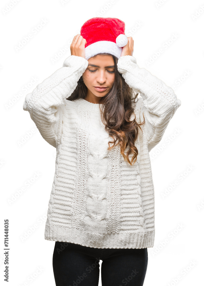 Young arab woman wearing christmas hat over isolated background suffering from headache desperate and stressed because pain and migraine. Hands on head. Young arab woman wearing christmas hat over isolated background suffering from headache desperate and stressed because pain and migraine. Hands on head.