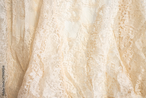 Texture of lace fabric. lace on a white background studio. thin fabric made of yarn or thread. usually one of cotton or silk, made by looping, twisting, or knitting thread in patterns photo
