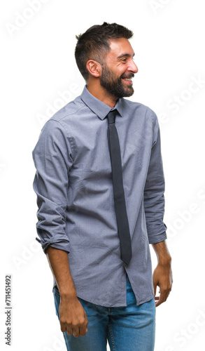 Adult hispanic business man over isolated background looking away to side with smile on face, natural expression. Laughing confident.