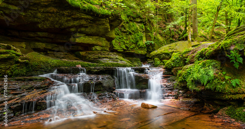 Panoramic view of Monbach creek valley with cascade near Bad Liebenzell in Black Forest, Germany. Blurred brook water motion with longtime exposure in an idyllic natural reserve after summer rainfall.